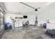 Spacious garage with laundry machines, storage shelves, high ceilings and white walls at 3909 Cr 532A, Bushnell, FL 33513