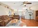 Spacious living room showcasing hardwood floors, comfortable seating, and an open layout for entertaining and relaxation at 3909 Cr 532A, Bushnell, FL 33513