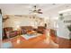 Bright living room featuring hardwood floors, comfortable seating, and an open layout leading to the kitchen and other areas at 3909 Cr 532A, Bushnell, FL 33513