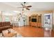 Open-concept living room featuring hardwood floors, plenty of space, and seamless connection to the kitchen area at 3909 Cr 532A, Bushnell, FL 33513
