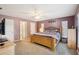 Comfortable main bedroom features a ceiling fan, plush carpeting, and ensuite bathroom access at 3909 Cr 532A, Bushnell, FL 33513
