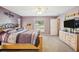 Spacious main bedroom with plush carpet, ensuite bathroom, and large window views at 3909 Cr 532A, Bushnell, FL 33513