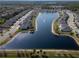 An aerial view of the neighborhood surrounding a scenic lake complete with fountain at 412 Lady Bella Pl, Deland, FL 32724