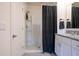 Clean bathroom featuring a shower with patterned curtain, vanity with granite countertop, and sleek mirror at 412 Lady Bella Pl, Deland, FL 32724