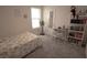 Cozy bedroom with bright window, fan, desk, shelving, and comfortable bed with floral comforter at 412 Lady Bella Pl, Deland, FL 32724
