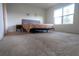 Spacious bedroom with neutral carpet, large bright window, and comfortable bed with upholstered headboard at 412 Lady Bella Pl, Deland, FL 32724