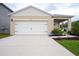 Charming single-story home featuring a two-car garage, well-maintained lawn, and manicured shrubbery at 412 Lady Bella Pl, Deland, FL 32724