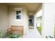 Inviting covered porch with a wooden bench, stylish decor, and an open view into the home at 412 Lady Bella Pl, Deland, FL 32724