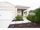 Inviting front porch with bench, manicured flower beds, and walkway with garden lights at 412 Lady Bella Pl, Deland, FL 32724