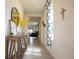 Bright hallway with a decorative mirror, stylish console table, and a view into the living spaces at 412 Lady Bella Pl, Deland, FL 32724
