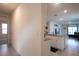 Hallway view of the kitchen with granite counters and the living room at 412 Lady Bella Pl, Deland, FL 32724