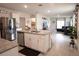Open concept kitchen features island, stainless steel appliances, and opens to the living area at 412 Lady Bella Pl, Deland, FL 32724