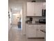 Hallway view of the kitchen with white cabinets and view to the entryway at 412 Lady Bella Pl, Deland, FL 32724