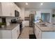 Modern kitchen featuring stainless steel appliances, granite countertops, and white cabinetry at 412 Lady Bella Pl, Deland, FL 32724