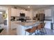 Open kitchen features white cabinets, granite counters, stainless appliances, and island with seating at 412 Lady Bella Pl, Deland, FL 32724