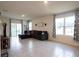 Bright living room with tile flooring, large windows, and sliding glass door to patio at 412 Lady Bella Pl, Deland, FL 32724