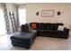 Comfortable living room with a large sectional sofa, neutral decor, and bright natural light at 412 Lady Bella Pl, Deland, FL 32724