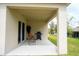 Relax on this covered patio with string lights, offering a perfect spot for outdoor enjoyment at 412 Lady Bella Pl, Deland, FL 32724