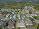 Expansive aerial view of a residential neighborhood with lovely homes, lush greenery and mature trees at 4712 St Andrews Arc, Leesburg, FL 34748
