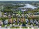 Aerial view of homes in a community near a lake, highlighting landscaping and location at 4712 St Andrews Arc, Leesburg, FL 34748