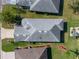 High-angle shot of a home with a gray roof and manicured lawns, complemented by the surrounding neighborhood at 4712 St Andrews Arc, Leesburg, FL 34748