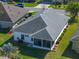 Aerial view of a well-maintained single-story home with a screened lanai and manicured landscaping at 4712 St Andrews Arc, Leesburg, FL 34748