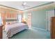 Serene bedroom featuring a comfortable bed, soft lighting, and a doorway leading to the en-suite bathroom at 4712 St Andrews Arc, Leesburg, FL 34748