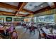 Spacious dining room with dark wood accents, large windows, and comfortable seating arrangements at 4712 St Andrews Arc, Leesburg, FL 34748