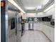 Bright kitchen featuring stainless steel appliances, white cabinetry, and ample counter space for food preparation at 4712 St Andrews Arc, Leesburg, FL 34748