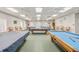 Pool room with several pool tables and ceiling fans at 4712 St Andrews Arc, Leesburg, FL 34748