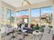 Bright sunroom with ample windows and comfortable seating perfect for relaxation and enjoyment at 4712 St Andrews Arc, Leesburg, FL 34748