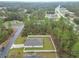 Aerial view of a well-maintained home with a fenced yard surrounded by lush greenery at 4923 Sw 166Th Loop, Ocala, FL 34473