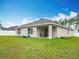 View of a backyard featuring a covered patio area with a table and chairs at 4923 Sw 166Th Loop, Ocala, FL 34473