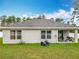 Exterior view displays the backyard, patio, and lush green surroundings at 4923 Sw 166Th Loop, Ocala, FL 34473