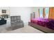 Bright bedroom with a comfy chair, a storage cabinet, a bed, and two windows at 4923 Sw 166Th Loop, Ocala, FL 34473