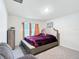 Bright bedroom with a comfy chair, a storage cabinet, a bed, and two windows at 4923 Sw 166Th Loop, Ocala, FL 34473