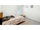 Simple bedroom with a patterned comforter, window with blinds, and carpeted floor at 4923 Sw 166Th Loop, Ocala, FL 34473