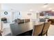 Spacious dining area adjacent to the kitchen with a large dark table and cushioned chairs at 4923 Sw 166Th Loop, Ocala, FL 34473
