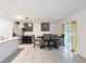 Bright dining area with stainless steel refrigerator and a dark table with upholstered chairs at 4923 Sw 166Th Loop, Ocala, FL 34473