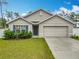 Charming single-story home with a well-maintained lawn, a two-car garage, and tasteful landscaping at 4923 Sw 166Th Loop, Ocala, FL 34473