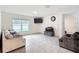 Bright living room featuring a large window, a wall-mounted TV, and comfortable seating arrangements at 4923 Sw 166Th Loop, Ocala, FL 34473