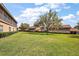 Beautiful backyard area, showcasing a well-maintained lawn with mature landscaping and surrounding homes at 5359 Compass Pt, Oxford, FL 34484