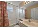 This bathroom offers a shower and tub combination, as well as an extended vanity with a large mirror at 5359 Compass Pt, Oxford, FL 34484