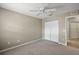 This bedroom features neutral walls, carpet, and a doorway leading to another room at 5359 Compass Pt, Oxford, FL 34484