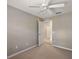 This bedroom features neutral walls, carpet, and a doorway leading to another room at 5359 Compass Pt, Oxford, FL 34484