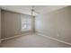 Bright bedroom featuring neutral walls, carpet, and a window with white shutter blinds and lots of natural light at 5359 Compass Pt, Oxford, FL 34484