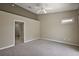 Neutral bedroom with a ceiling fan and carpeted floors at 5359 Compass Pt, Oxford, FL 34484