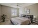 This bedroom features neutral walls, carpet, and a window with white shutter blinds and lots of natural light at 5359 Compass Pt, Oxford, FL 34484