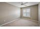 Bright bedroom featuring neutral walls, carpet, and a window with white shutter blinds and lots of natural light at 5359 Compass Pt, Oxford, FL 34484