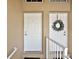 A closer view of the front doors to the townhouses with one adorned with a wreath and a white railing at 5359 Compass Pt, Oxford, FL 34484